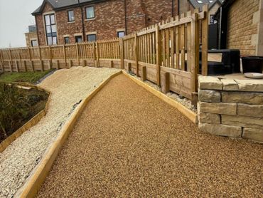 A resin surface in a garden with the new sand colour resin being applied.
