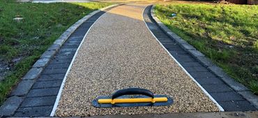 A newly installed resin surface over the current path in the rear of a garden.