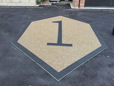 A numbe 1 in a resin triangle being applied to a new resin bound driveway.