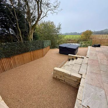 Another surface in a garden with the new sand colour resin being applied with steps.