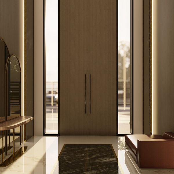 Elegant modern entryway with tall wooden doors and sleek furniture.
