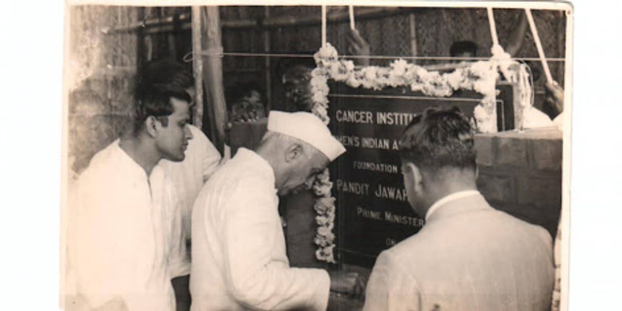 Black and white photo of Jawaharlal Nehru inaugurating a Cancer Institute plaque.