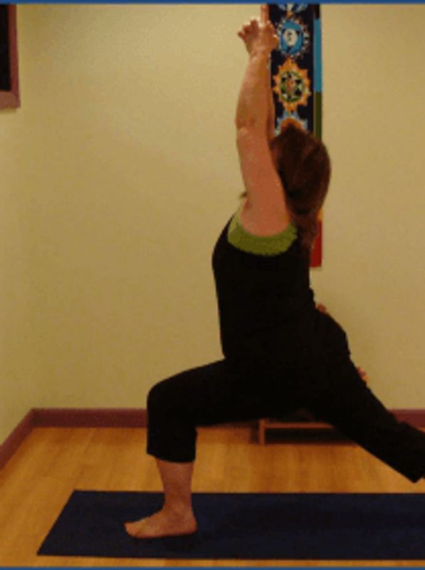 Person doing a yoga pose indoors on a blue mat.