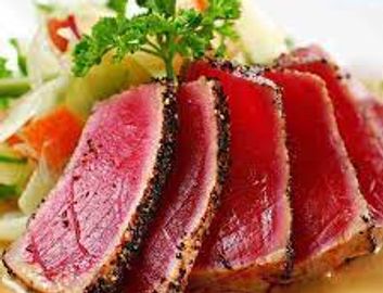 Sushi grade Ahi Tuna cajun seasoned and seared VERY RARE) in a red hot skillet served thinly sliced 