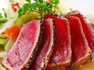 Sushi grade Ahi Tuna cajun seasoned and seared VERY RARE) in a red hot skillet served thinly sliced 