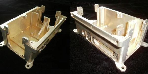 Two angled views of a metallic, precision-machined enclosure on a black background.