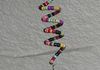 Beaded spinning suncatcher in Aztec colors/style by Savannah (Sharon does charm/chain).