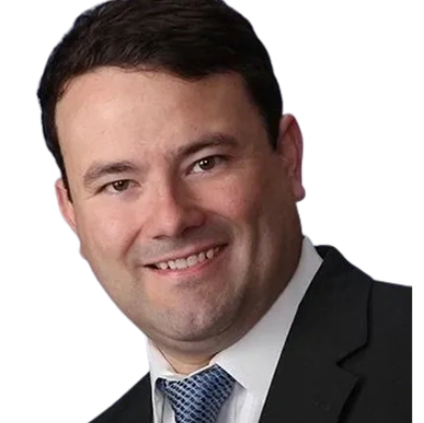Man in business suit smiling.