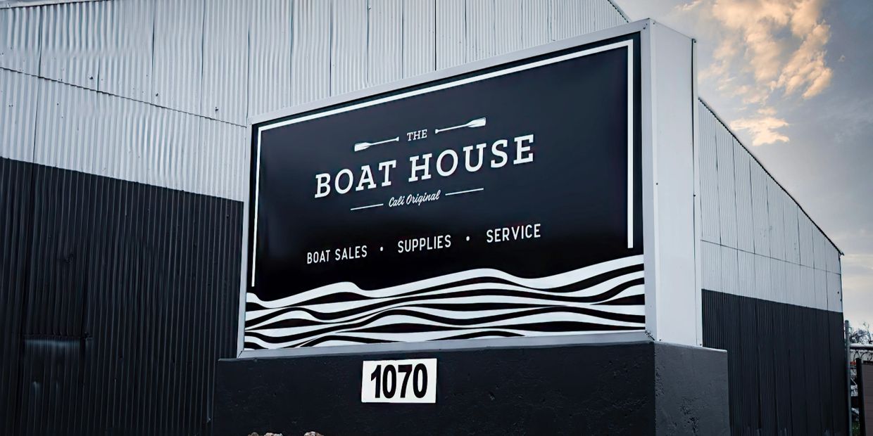 Sign for The Boat House offering boat sales, supplies, and service at 1070.