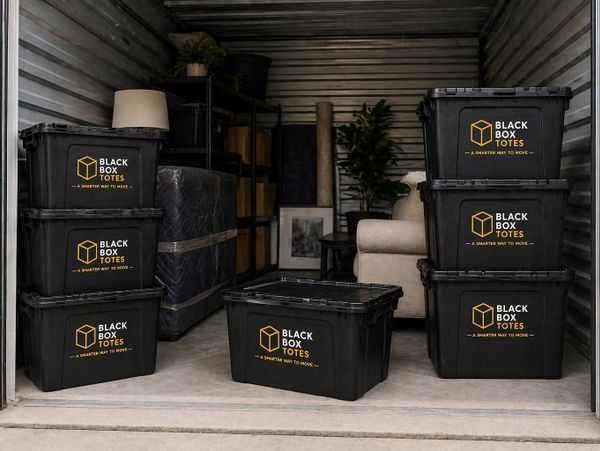Black Box Totes stacked and stored in a moving storage unit.