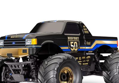Black and gold Bigfoot 50 Years monster truck with large tires.