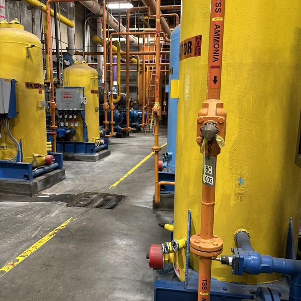 Industrial ammonia storage tanks and piping inside a facility.