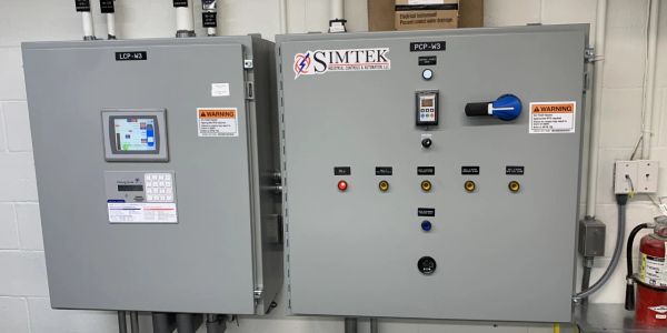 Industrial control panels by SIMTEK in a facility.