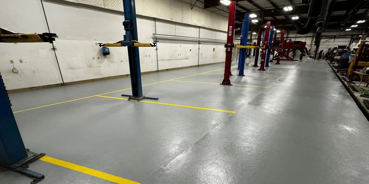 Commercial automotive quartz epoxy floor installed in Traverse City, MI by Full Spectrum Coatings.