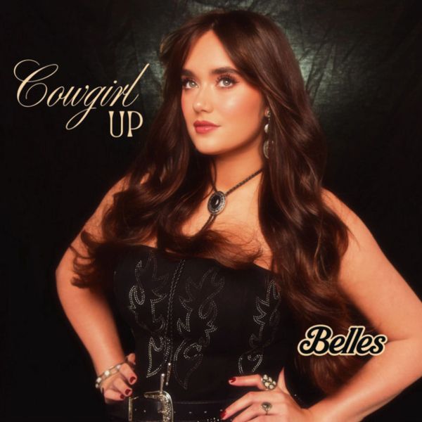 Woman with long hair in a black outfit titled 'Cowgirl Up'.