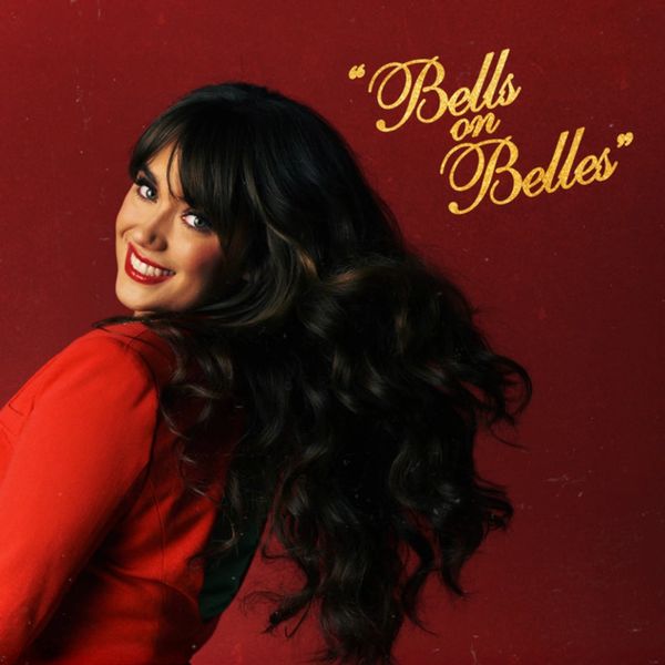 Woman in red dress with long dark hair smiles.