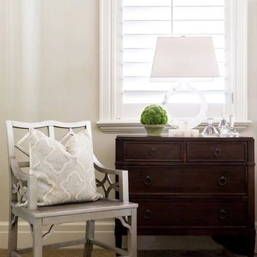 Classic bedroom corner with dresser and chair.