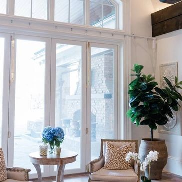 Sunlit sitting area with large glass doors.
