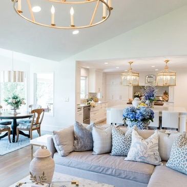 Bright open-concept living room with blue accents.