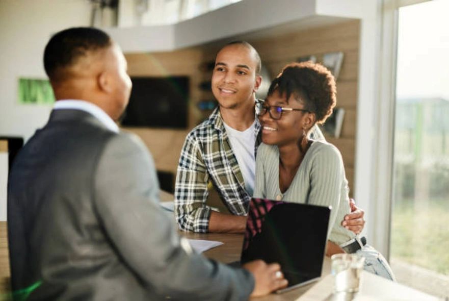 Black Mortgage Loan Officer helping a homebuying couple