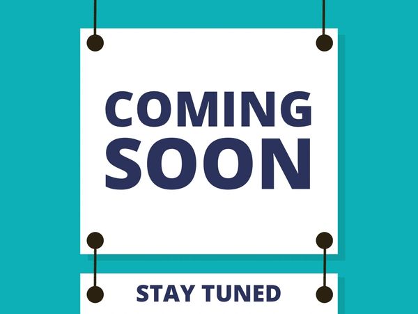 Sign saying 'Coming Soon' and 'Stay Tuned' on blue background.
