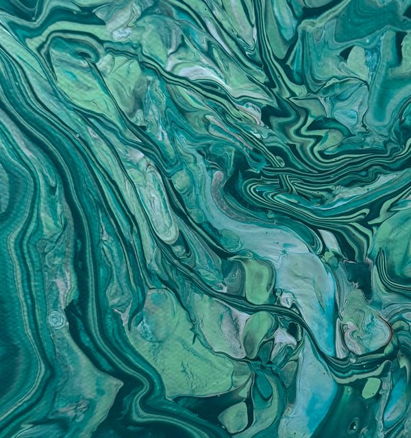 Abstract swirling green and blue marble pattern.
