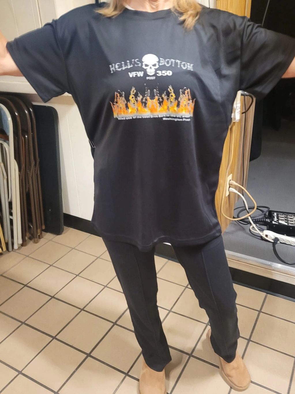 Person wearing a black Hell's Bottom VFW 350 t-shirt with flames and skull design.