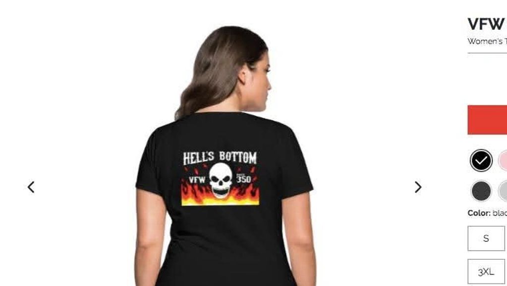Woman wearing black t-shirt with skull and flames design labeled 'HELL'S BOTTOM VFW 350'.