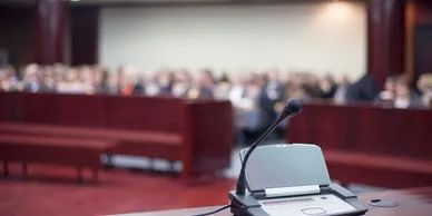Empty microphone on a desk in a conference room.