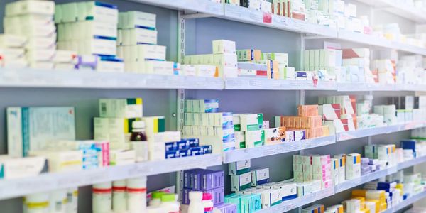 Pharmacy shelf with many different medicines. Signifies broad expertise at Hilaxon.