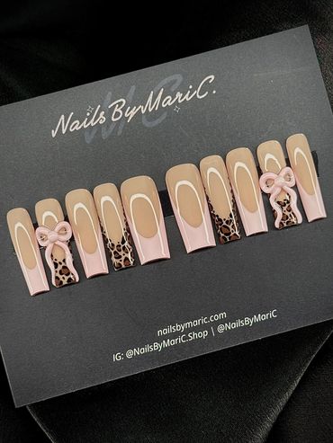 Set of acrylic nails with nude, pink, leopard print, and bow designs.