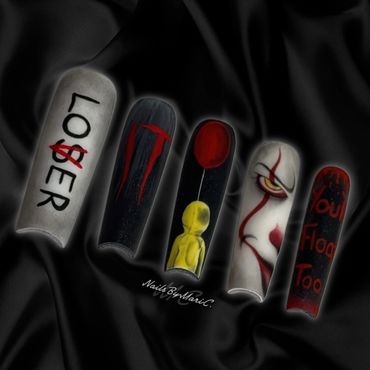 Fingertips painted with horror-themed designs inspired by Stephen King's It.