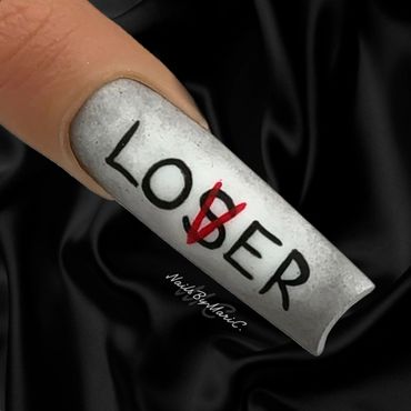 White nail art with the word 'LOSER' crossed to 'LOVER'.