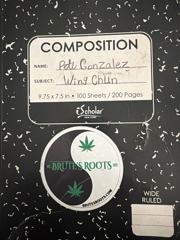Close-up of a composition notebook with handwritten name and subject.