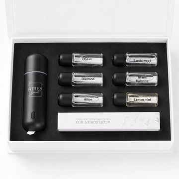 A sleek fragrance diffuser set with six scent vials and a black diffuser device.