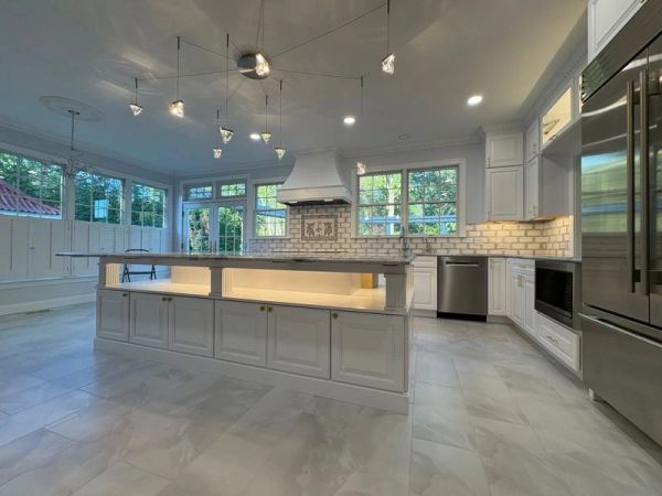 Bright modern kitchen with white cabinetry and island.