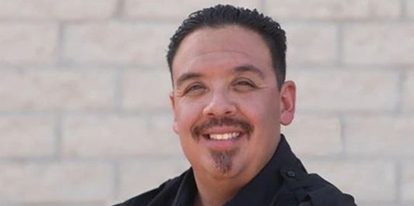 Smiling man in a black shirt.