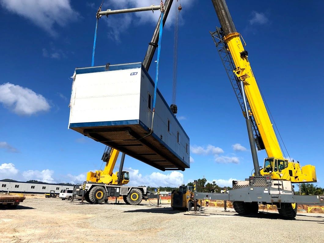 Crane set of a modular unit for a man camp relocation from Canada to St. Croix USVI