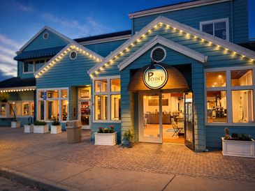 Cozy restaurant entrance lit warmly at dusk.