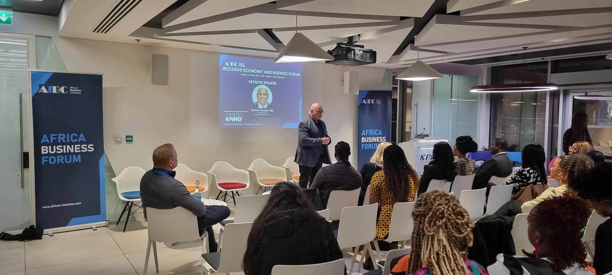 Speaker presenting at the Africa Business Forum with an engaged audience.