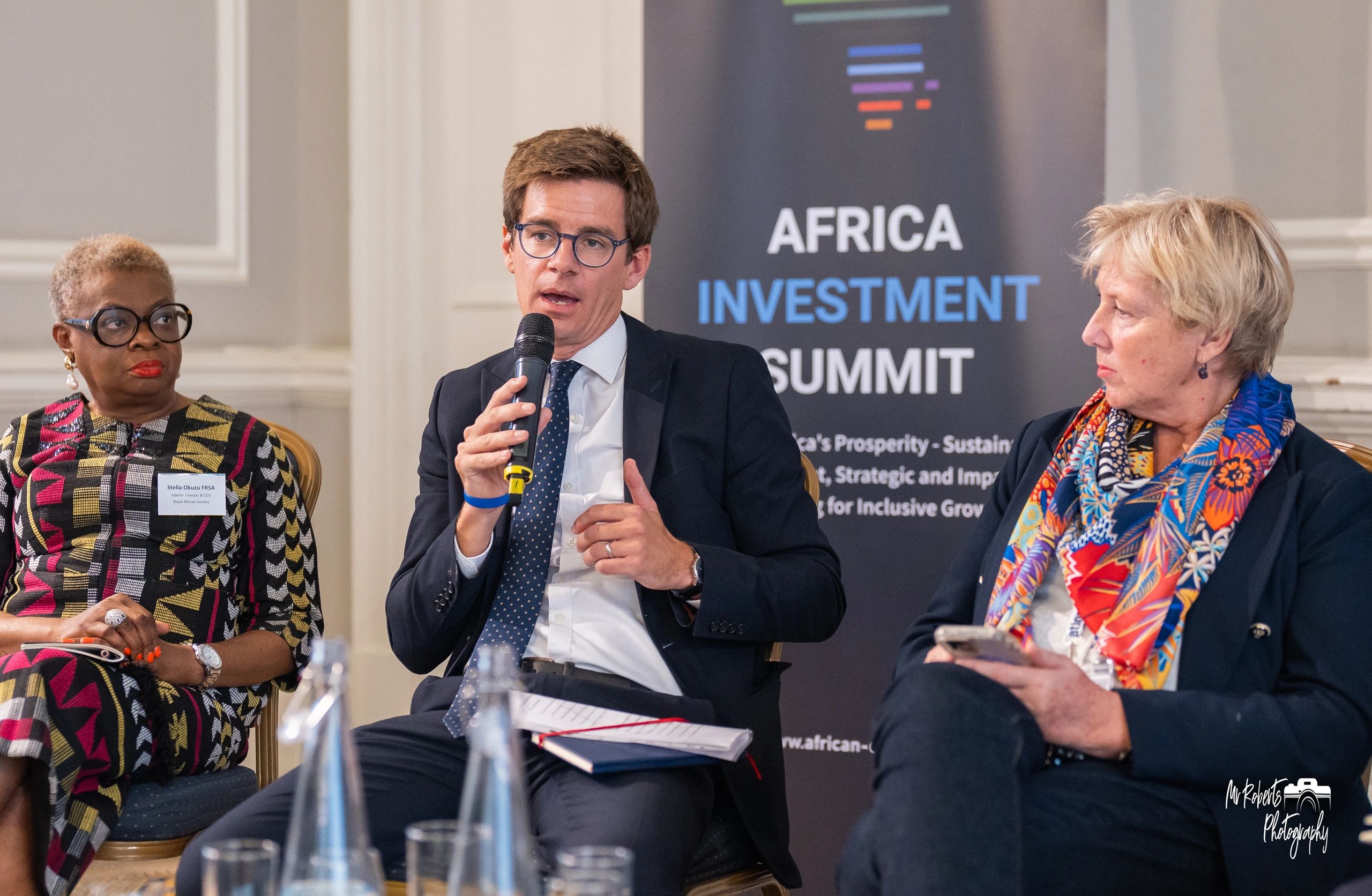 Panel discussion at Africa Investment Summit with diverse speakers.