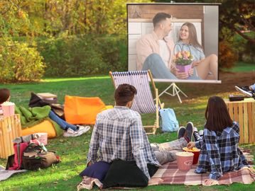 Friends watching movie in outdoor cinema