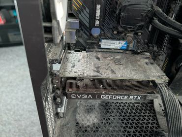 Dusty EVGA GeForce RTX graphics card inside a PC case.