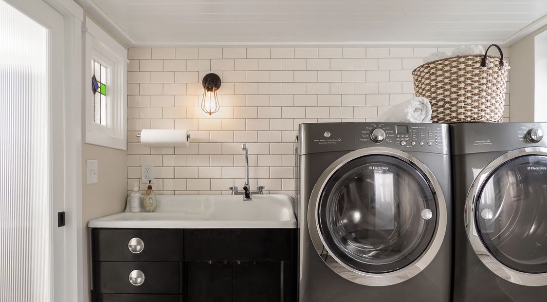 POP remodeled laundry room with vintage sink and subway tile