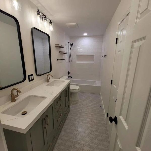 Modern bathroom with dual sinks and bathtub.
