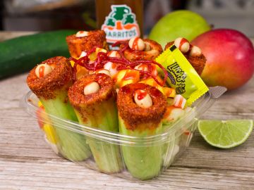 Mexican snack cups with cucumber, chamoy, and candy in a plastic container.