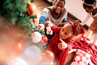 Stock image of a family decorating a tree