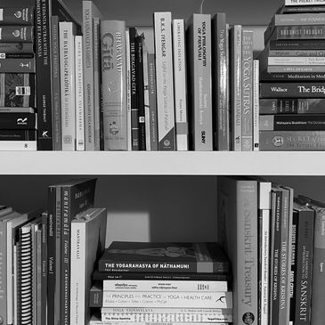 Bookshelves filled with yoga, philosophy, and spirituality books.