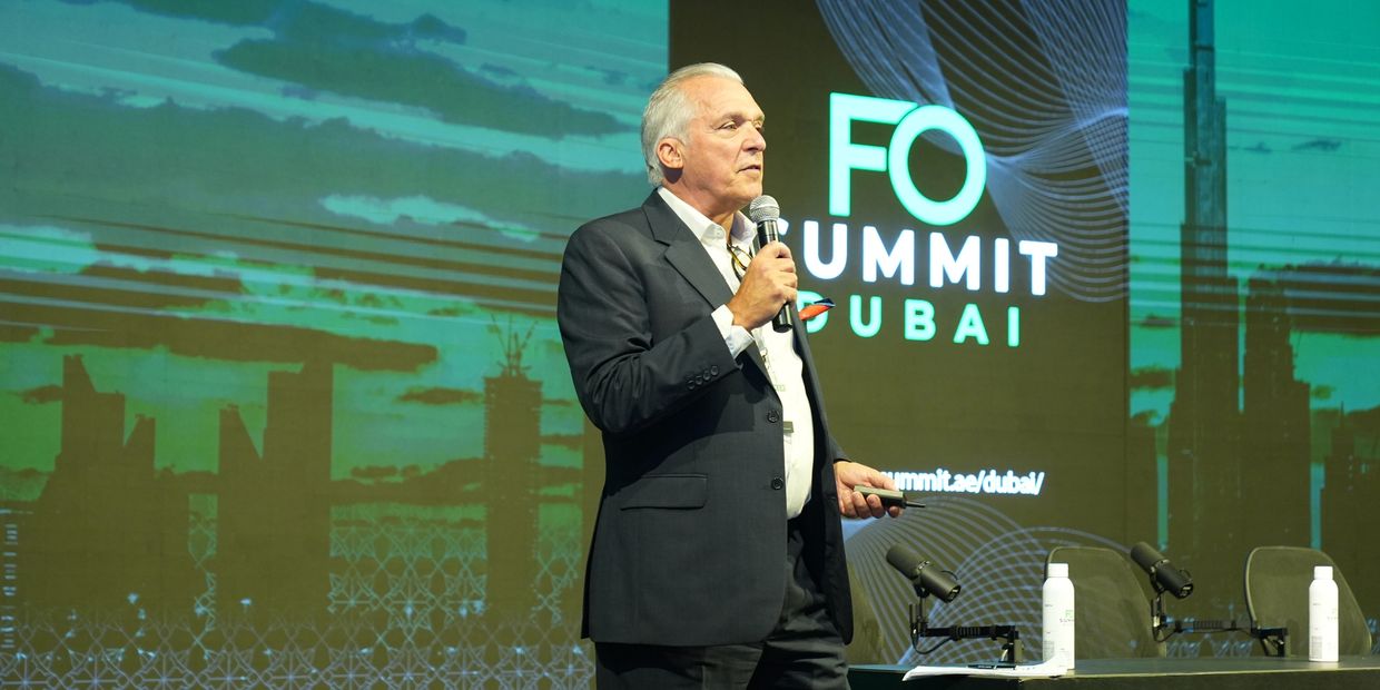 A man in a suit speaking at the FO Summit Dubai event.