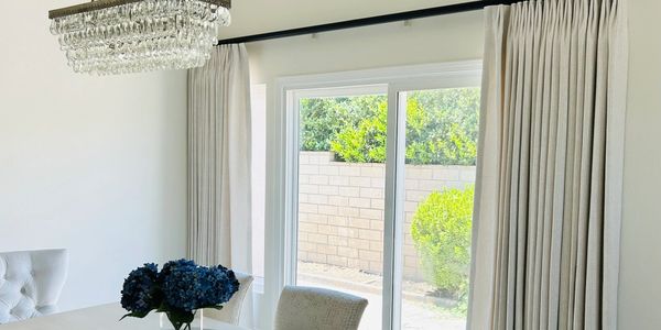 Elegant drapery framing large windows in Newport Beach, CA